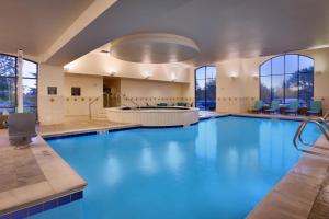 a large swimming pool with blue water in a building at Residence Inn by Marriott Idaho Falls in Idaho Falls