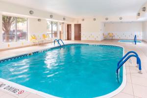 a large swimming pool in a hotel room with a pool at Fairfield Inn & Suites Lubbock in Lubbock