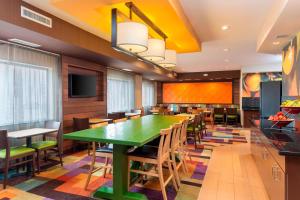a dining room with a green table and chairs at Fairfield Inn & Suites Lubbock in Lubbock