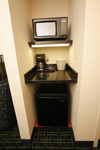 a microwave sitting on a shelf in a room at Fairfield by Marriott Inn & Suites Melbourne West/Palm Bay in Melbourne