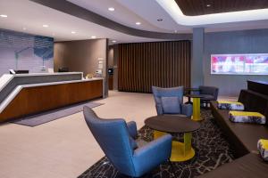 a lobby with blue chairs and a waiting room at SpringHill Suites by Marriott Elizabethtown in Elizabethtown