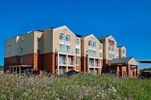 a building with a field of flowers in front of it at Fairfield Inn & Suites by Marriott Fairfield Napa Valley Area in Fairfield