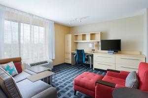 a living room with a couch and a table and a tv at TownePlace Suites by Marriott Bossier City in Bossier City