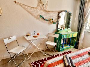 a room with a table and chairs and a mirror at City Dacha - Ocean in Albufeira