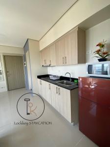 a kitchen with a sink and a red refrigerator at 180 degree view of manila bay in Manila