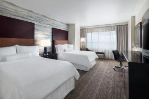 a hotel room with two beds and a television at The Westin Washington National Harbor in National Harbor