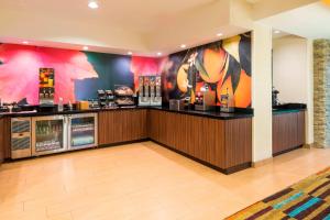 a restaurant with a bar with colorful walls at Fairfield Inn and Suites Mobile in Mobile