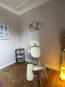 a hair salon with two white chairs and a hair dryer at La Tirelire in Cosswiller