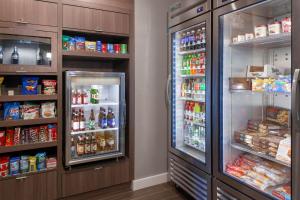 a room with two refrigerators and lots of food at Residence Inn by Marriott St. Louis West County in Saint Louis