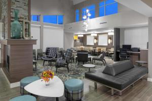 a waiting room with a couch and chairs and tables at Residence Inn by Marriott St. Louis West County in Saint Louis