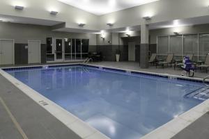 a large swimming pool with blue water at Residence Inn by Marriott St. Louis West County in Saint Louis