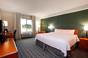 a hotel room with a large bed and a window at Marriott Fairfield Sudbury in Sudbury