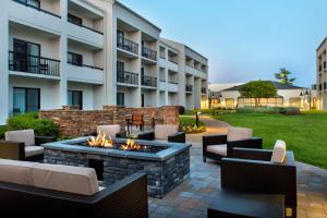 a patio with a fire pit in front of a building at Courtyard by Marriott Silver Spring North/White Oak in Silver Spring