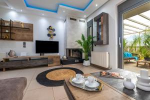 a living room with a tv and a table at Delight Luxury Residences - Souda in Souda