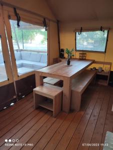 a wooden table and bench in a room with a couch at Analaya in Vias