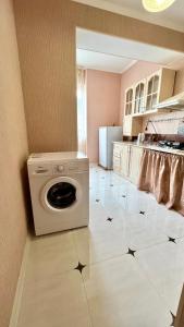 a kitchen with a washing machine in a room at Квартира рядом с морем (3-х комнатная) in Gagra