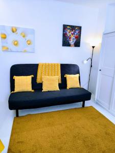 ein blaues Sofa mit gelben Kissen im Wohnzimmer in der Unterkunft Ca' Sistina Yellow in Morcote