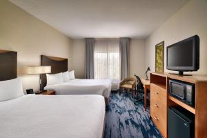 a hotel room with two beds and a flat screen tv at Fairfield Inn & Suites by Marriott Tallahassee Central in Tallahassee