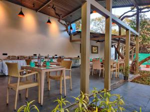 an outdoor dining area with tables and chairs at Advait Valley Camp, Kshetra Mahabaleshwar in Mahabaleshwar