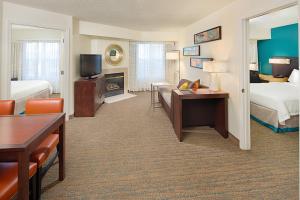 a hotel room with two beds and a living room at Residence Inn Richmond Northwest in Broad Meadows