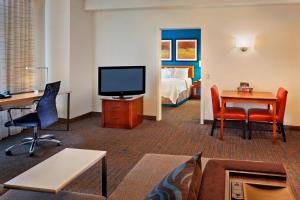 a hotel room with a television and a bedroom at Residence Inn Philadelphia Conshohocken in Conshohocken