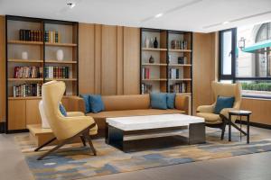 a living room with a couch and two chairs at Fairfield by Marriott Shanghai Jingan in Shanghai