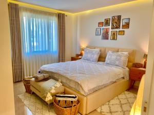 a bedroom with a large bed and a window at Beach Garden Paradise in Durrës