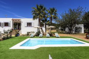 a swimming pool in the yard of a house at Can Prats Country House in Sant Josep de Sa Talaia