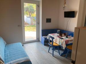 a living room with a table and a blue couch at La Perla di Buffari Appartamento Ciappina in Palmi