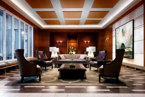 a living room with a couch and chairs at Le Westin Montreal in Montréal