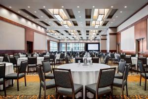 a large room with tables and chairs and a projection screen at Le Westin Montreal in Montreal