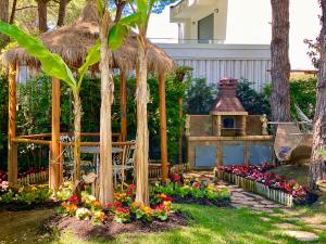 a garden with a gazebo and flowers at Beach Garden Paradise in Durrës