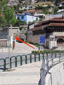 an orange umbrella is flying over a city street at Guest House Noah&Kristel in Berat