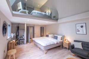 a bedroom with a king sized bed and a living room at The Arran, St Andrews in St. Andrews