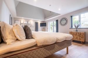 a bedroom with a large bed with white sheets and pillows at The Arran, St Andrews in St. Andrews