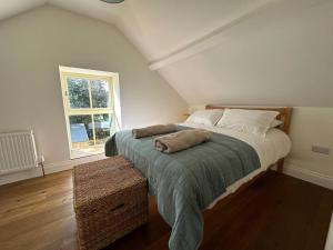 a bedroom with a bed and a window at Murphy's Mountain Cottage in Clonmel