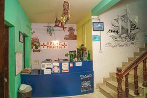 a room with stairs and signs on the wall at Santa Maria Hostel, Fort Kochi in Cochin