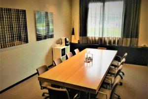 a conference room with a wooden table and chairs at AC Hotel Padova by Marriott in Padova