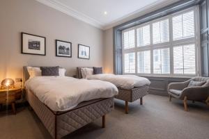 a bedroom with two beds and a window at The Arran, St Andrews in St. Andrews