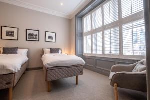 a bedroom with two beds and a window at The Arran, St Andrews in St. Andrews