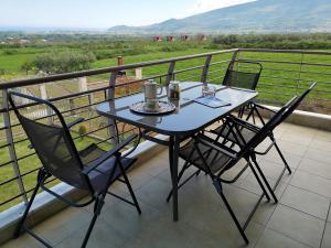 a table and two chairs on a balcony at Elioj house in Leptokarya