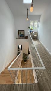 a staircase in a home with white walls and wood floors at Apartamentos turísticos Praia de Seselle, terraza y jardín a un paso de la playa in Ares
