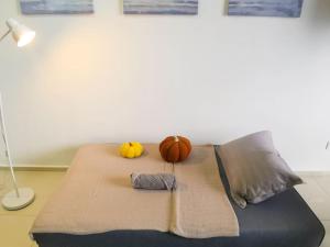 a bed with three pumpkins on top of it at EkoCheras Loft 5 pax, #Snooker #AboveMall #Balcony #FreeCarPark in Kuala Lumpur +40 photos