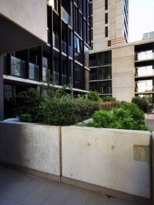 a concrete planter with plants in front of a building at Dudley Cosy 2 beds 2 Baths with free parking in Melbourne