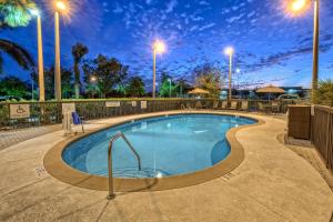 a swimming pool at night with street lights at Fairfield Inn and Suites by Marriott Naples in Naples