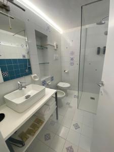 a bathroom with a sink and a shower and a toilet at DUOMO26 BOUTIQUE APARTMENT in Desenzano del Garda