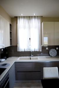 a kitchen with a large sink and a window at Elioj house in Leptokaria +71 photos