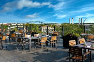 a restaurant with tables and chairs on a roof at AC Hotel by Marriott Portsmouth Downtown/Waterfront in Portsmouth