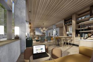 a living room with a laptop on a table at Residence Inn by Marriott Paris Charles de Gaulle Central Airport in Roissy-en-France