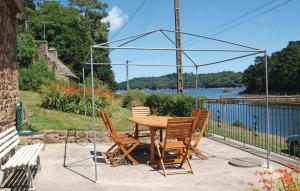 a table and chairs with a view of the water at Beautiful Home In Lezardrieux With 2 Bedrooms And Wifi in Lézardrieux